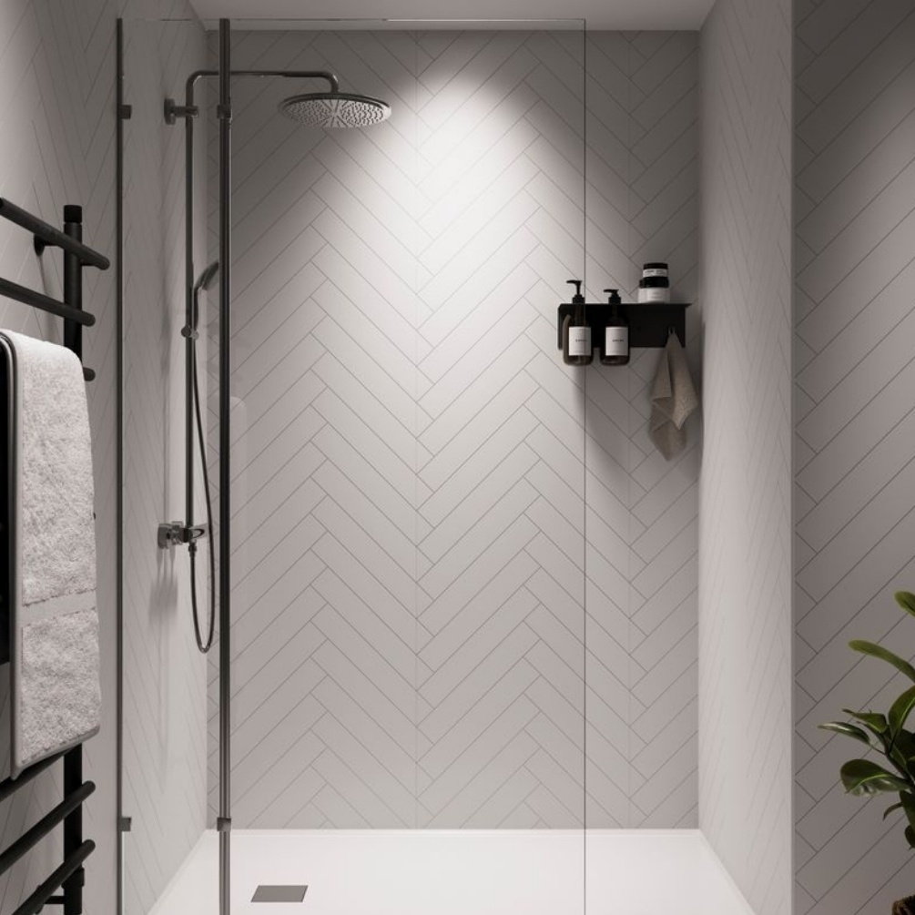 Lifestyle image of the Showerwall Laminate Snow White 2400mm x 600mm Herringbone Tile Effect Wall Panel - SWT02 installed in a walk-in shower enclosure